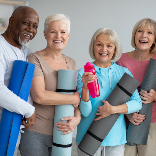 Group of seniors with yoga mats