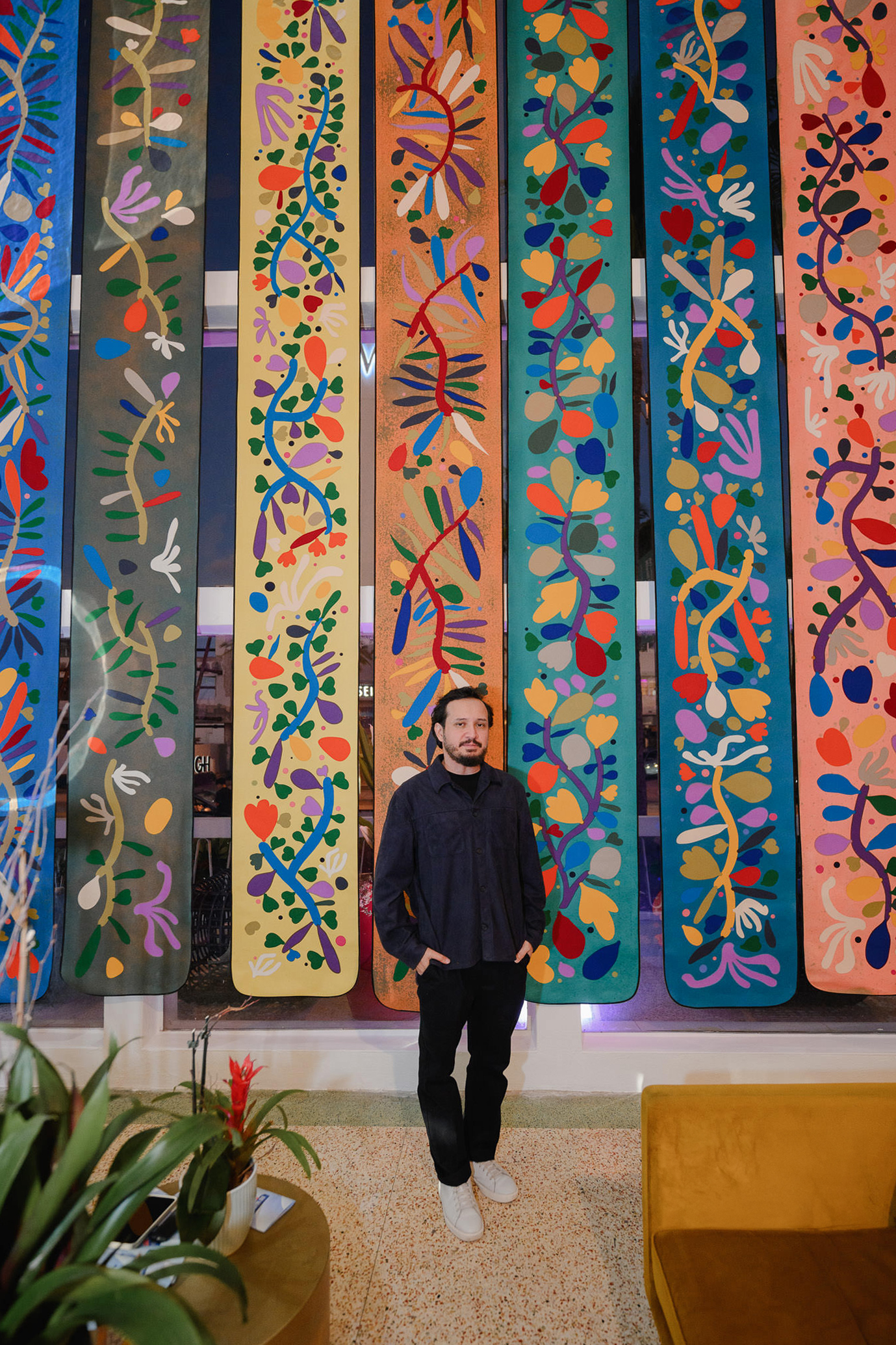 edison penafiel standing in front of artwork