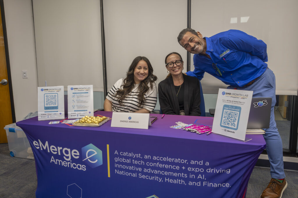 Representatives from eMerge Americas' SMB Growth Lab and Economic Development Department greet attendees during Miami Beach’s Business Concierge and Licensing Day, offering resources and information to help small businesses grow and innovate.