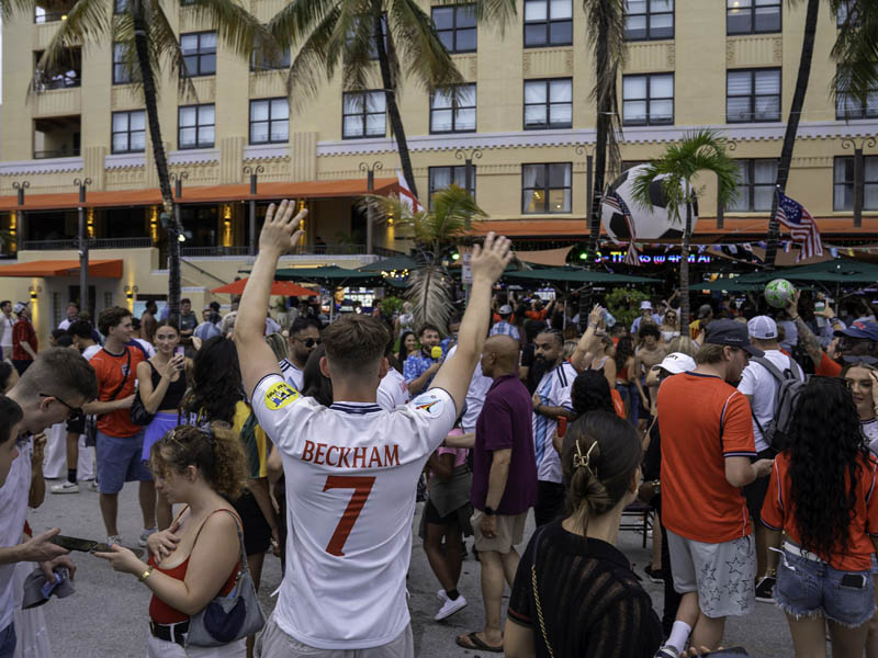 back of man in Beckham jersey in front of crowd