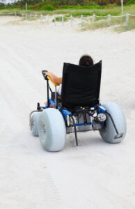 person at beach with a wheelchair