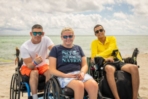people at the beach using wheelchairs