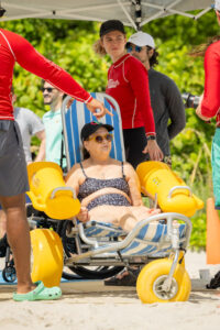 handicap person in beach access assisted beach chair