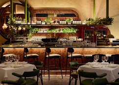 Interior of Ezio’s Restaurant with bar seating, warm lighting, and an intimate dining atmosphere.