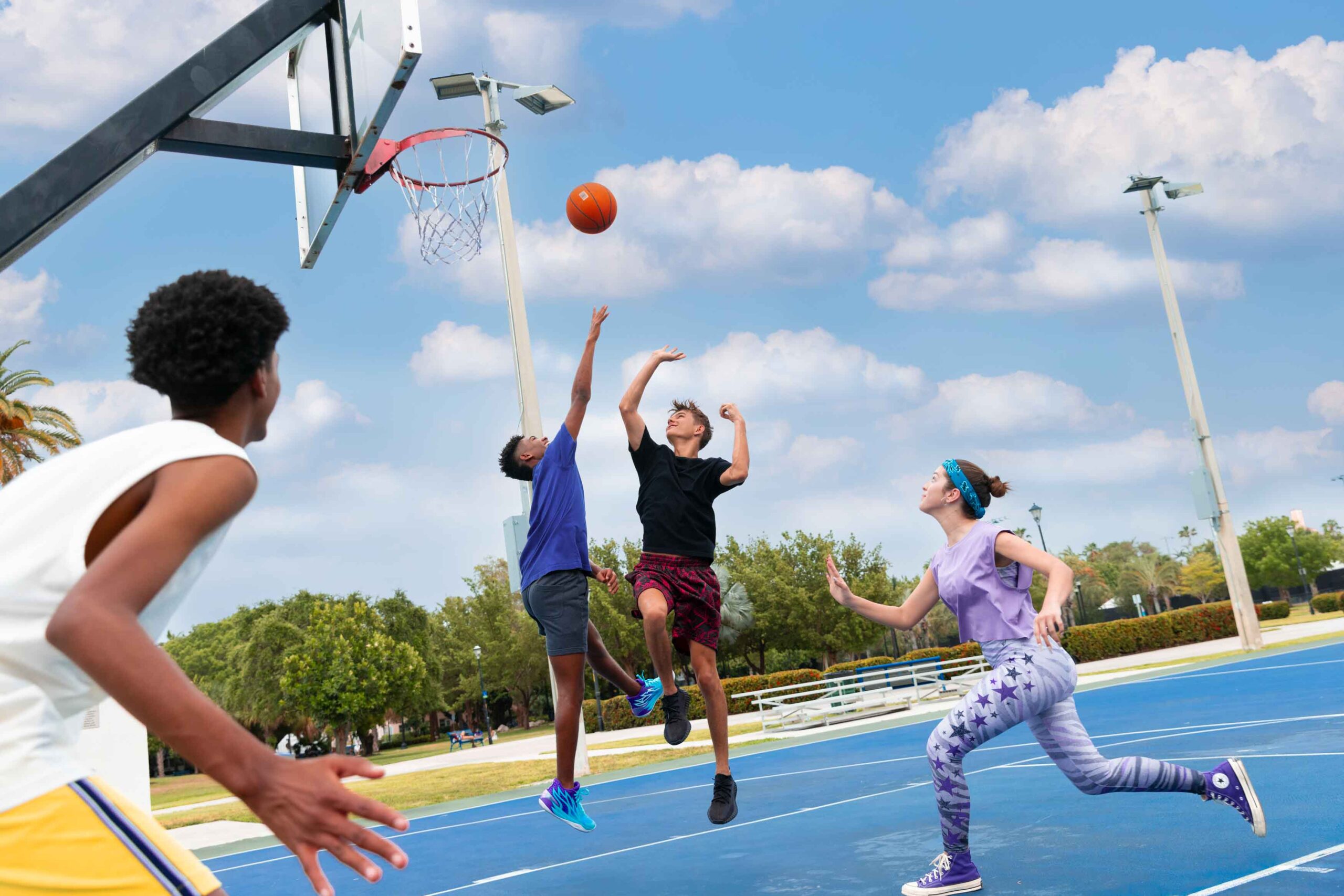 boys and girl playing basketball