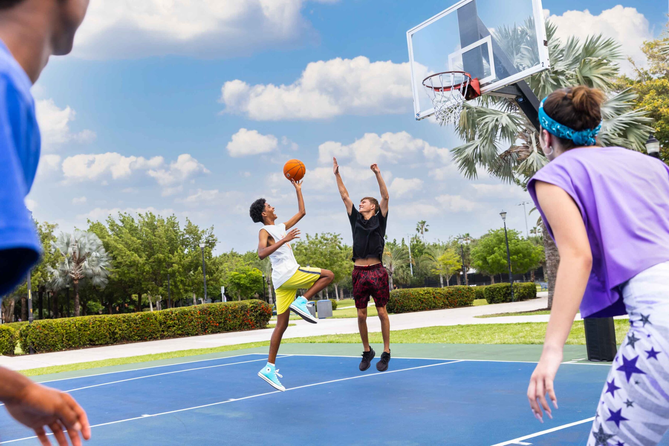 boys and girl playing basketball