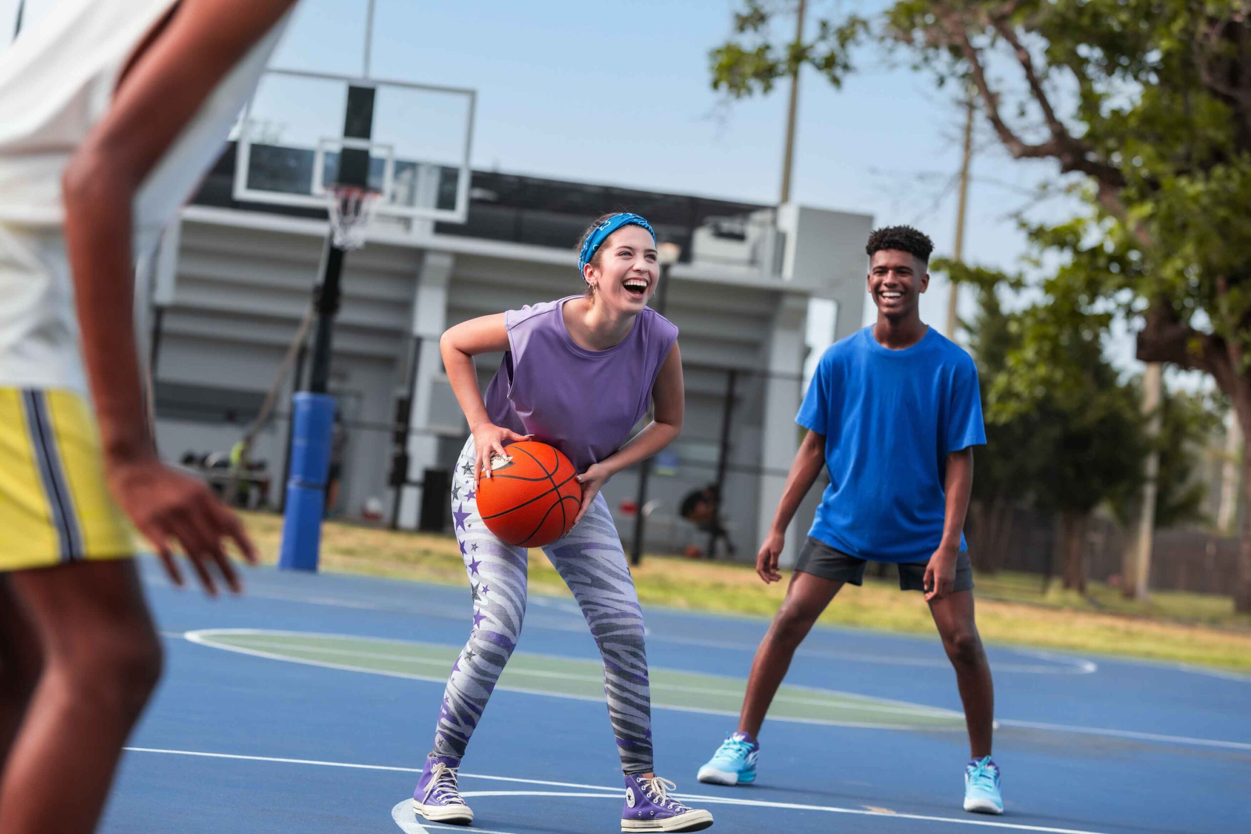 boy and girl playing basketball
