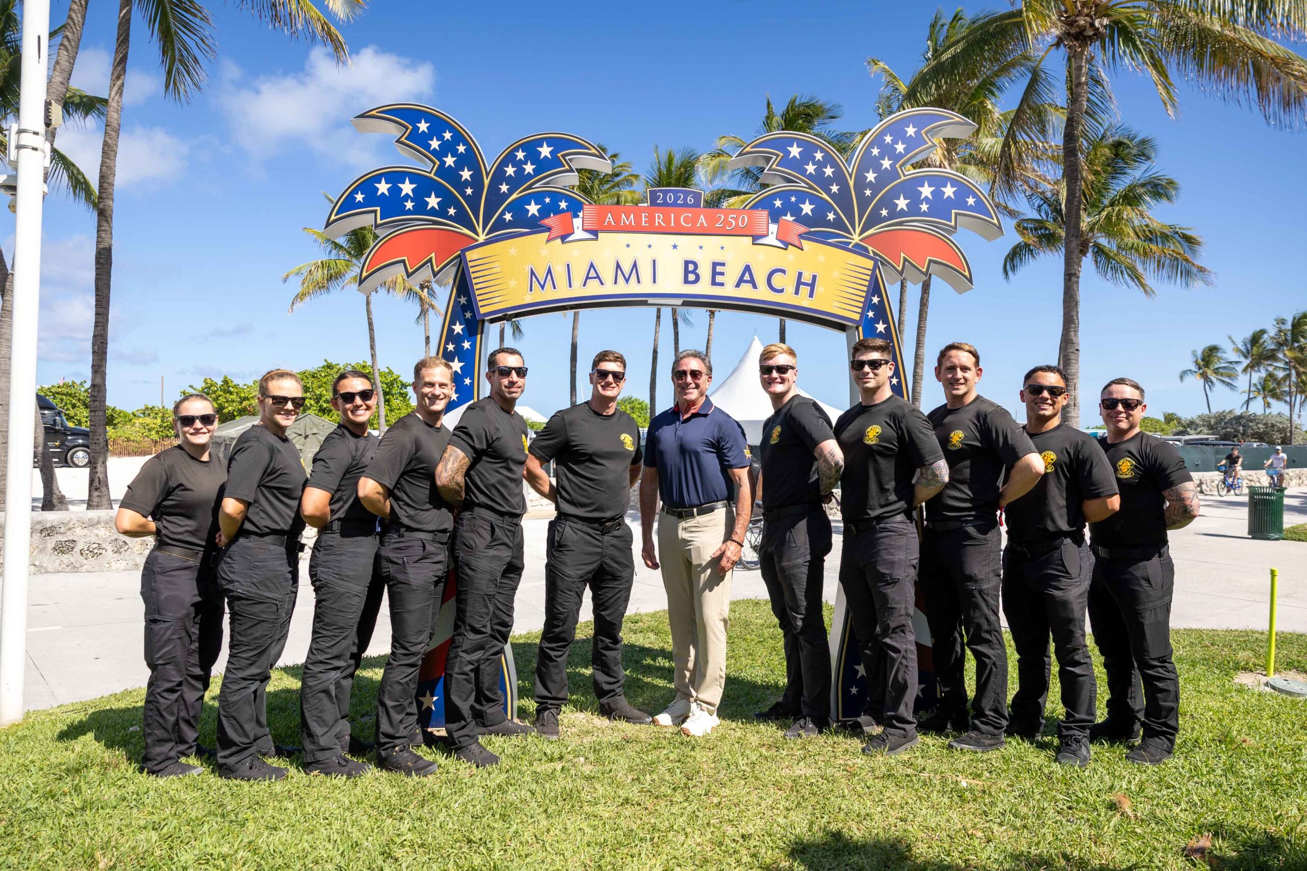 group picture under Miami Beach America 250 prop
