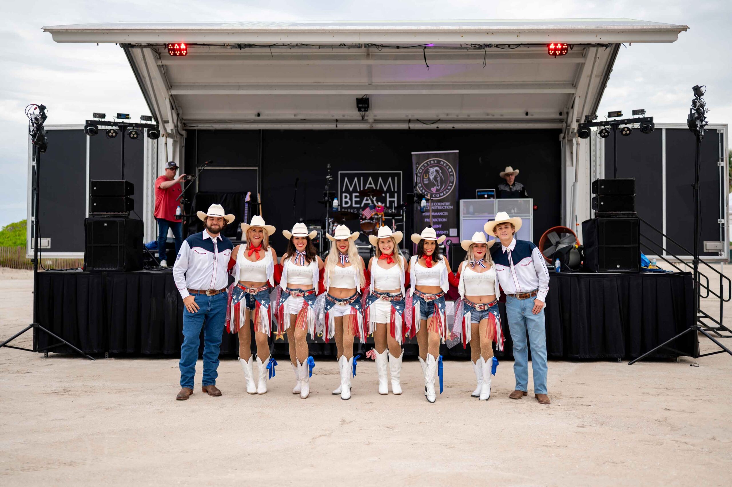 group picture of line dancers in front of stage