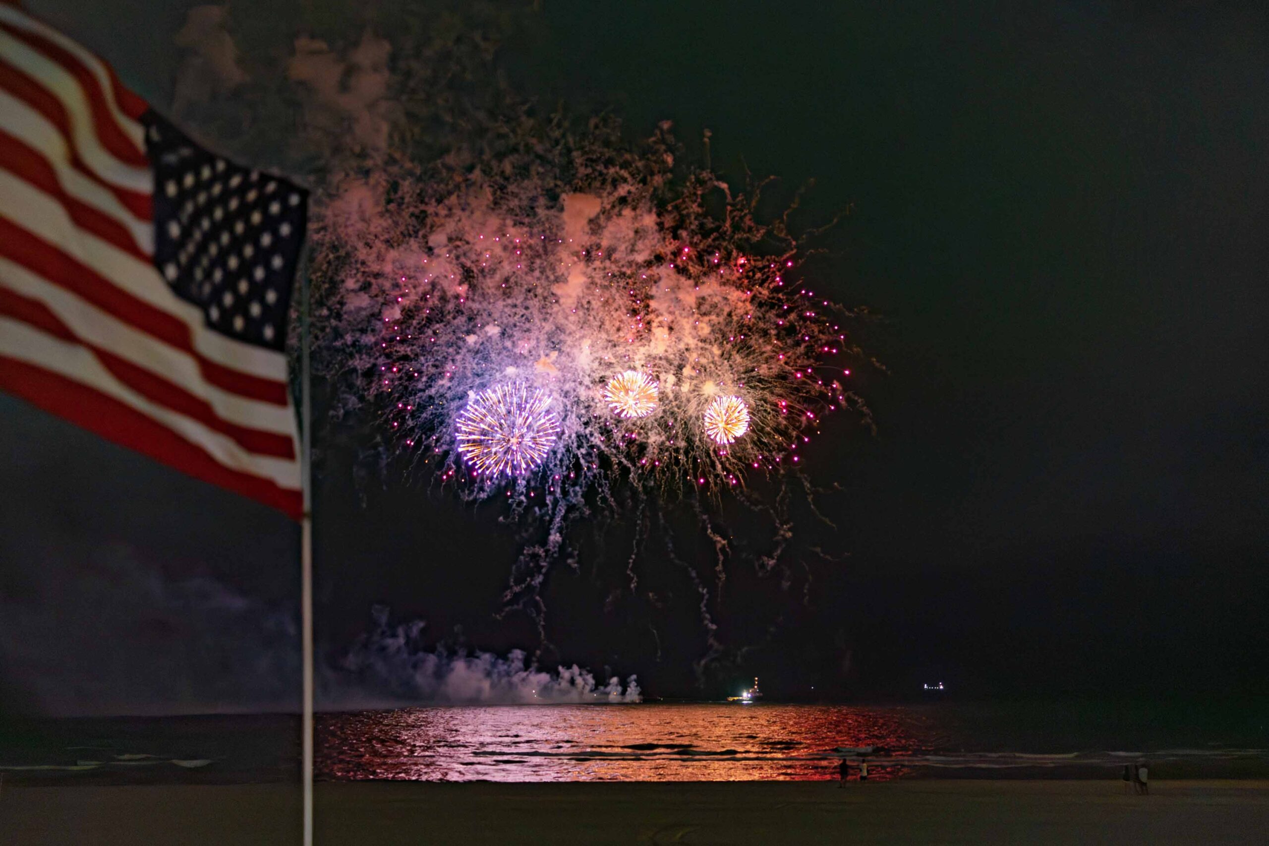 fireworks behind american flag