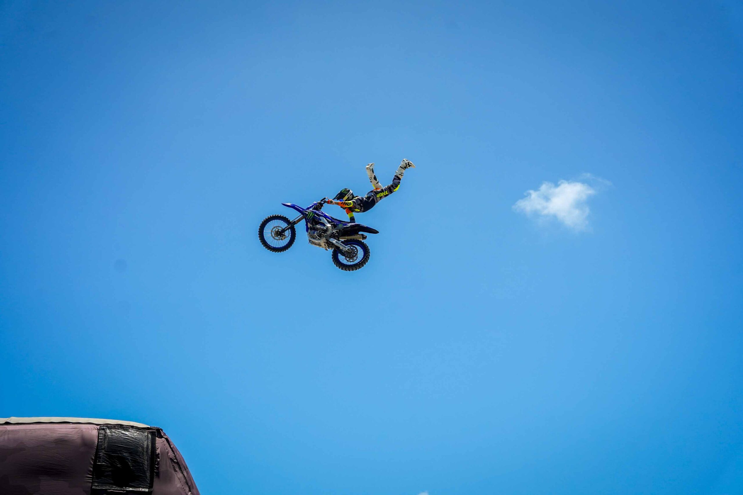 dirtbike in air with rider doing tricks
