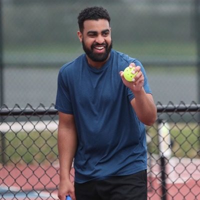 man holding a pickleball