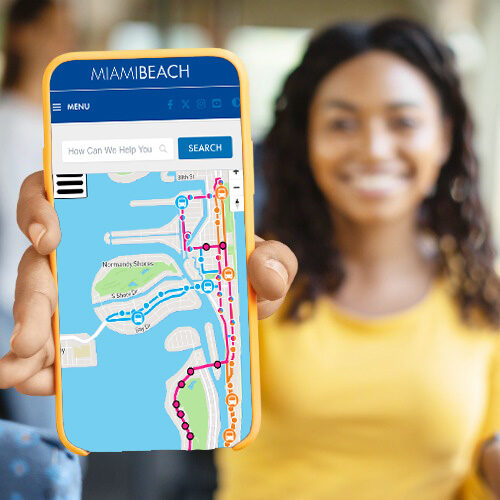 person on a bus showing the trolley tracker on her mobile phone