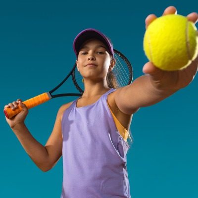 girl with tennis raquet and ball